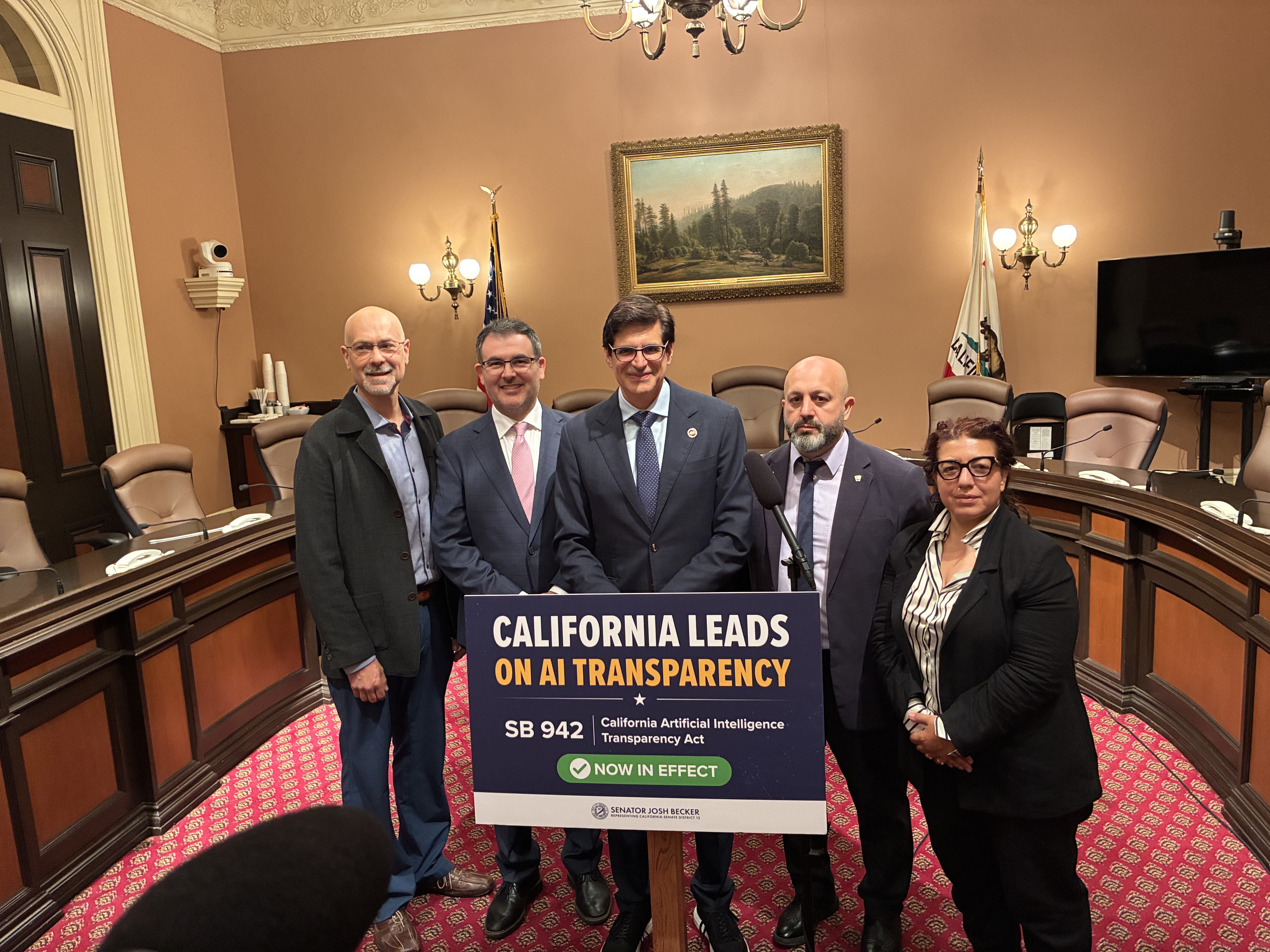 Burhan Yanbolu on stage with California State Senator Josh Becker at the SB 942 AI Transparency Act launch event, Sacramento